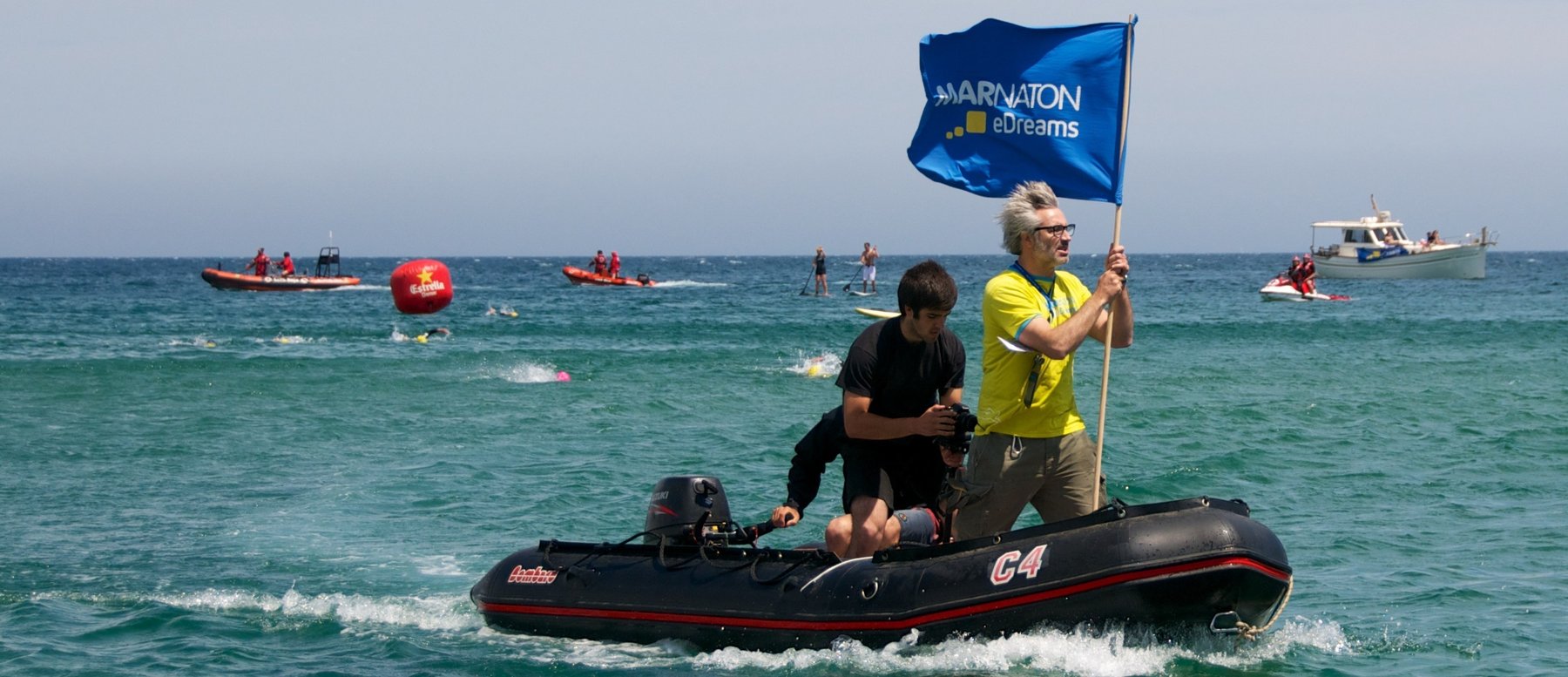 Miguel Rahola with a Marnaton flag on a support boat during a race
